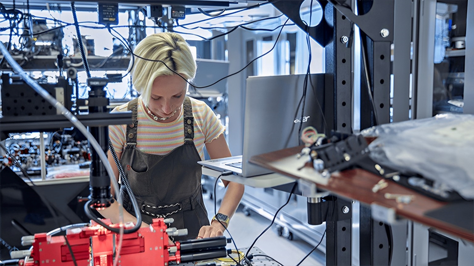 Xanadu Hardware Team Member works at an optical table in the Xanadu lab.