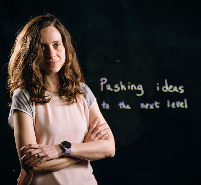 Leyla Soleymani standing in front of a black background with the words: Pushing ideas to the next level
