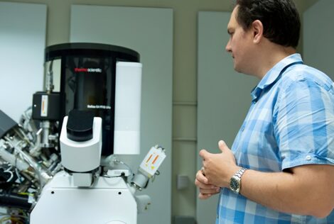Nabil Bassim looking at a machine in his lab