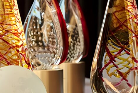 Close up of glass awards with red and yellow swirled through them