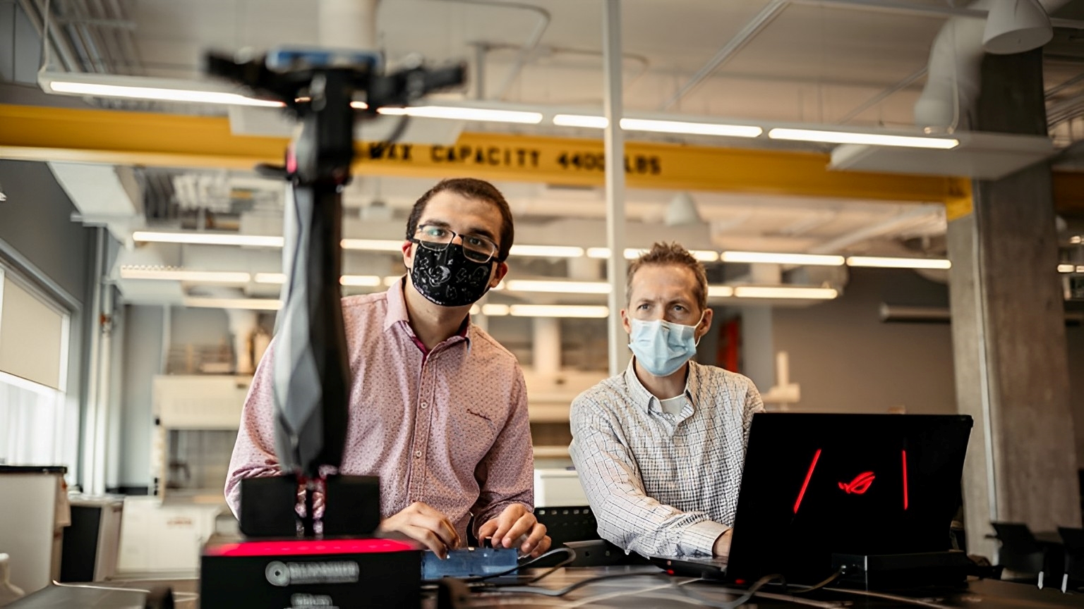 Engineering student AJ Kourabi and Prof Colin McDonald test a robotic arm made by Quanser, one of the high-tech gear students use in design projects throughout the year.