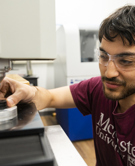 Student working on a machine at McMaster's Manufacturing Research Institute