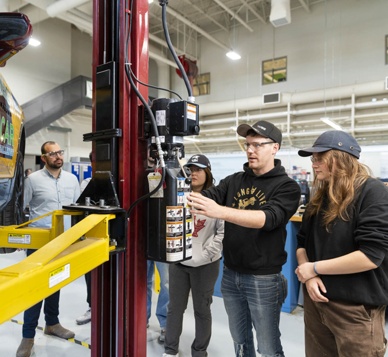 Students gathered around automotive equipment