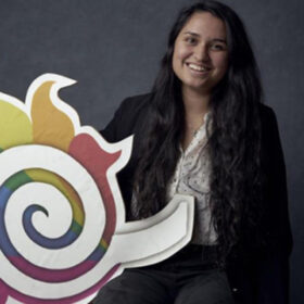 Vanessa Raponi poses with a rainbow fireball.