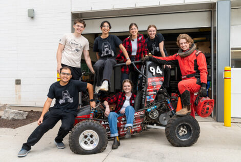 The Baja Racing team poses with their off-road vehicle.