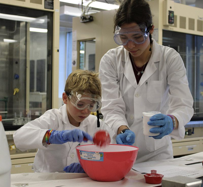 Camper and instructor working on a chemistry experiment