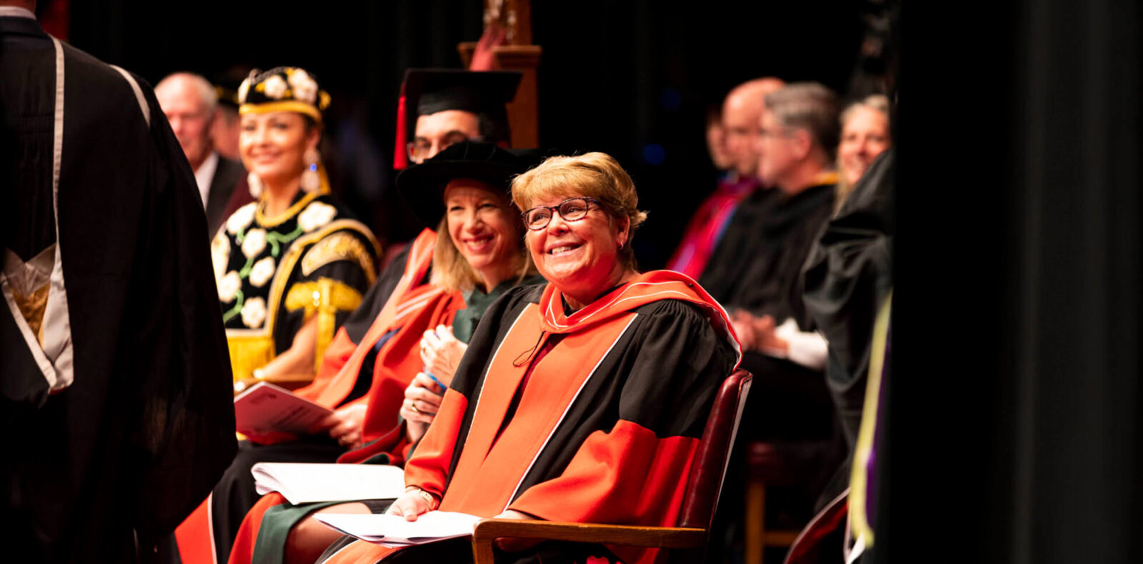 Dean Heather Sheardown smiles at a student on stage at convocation.