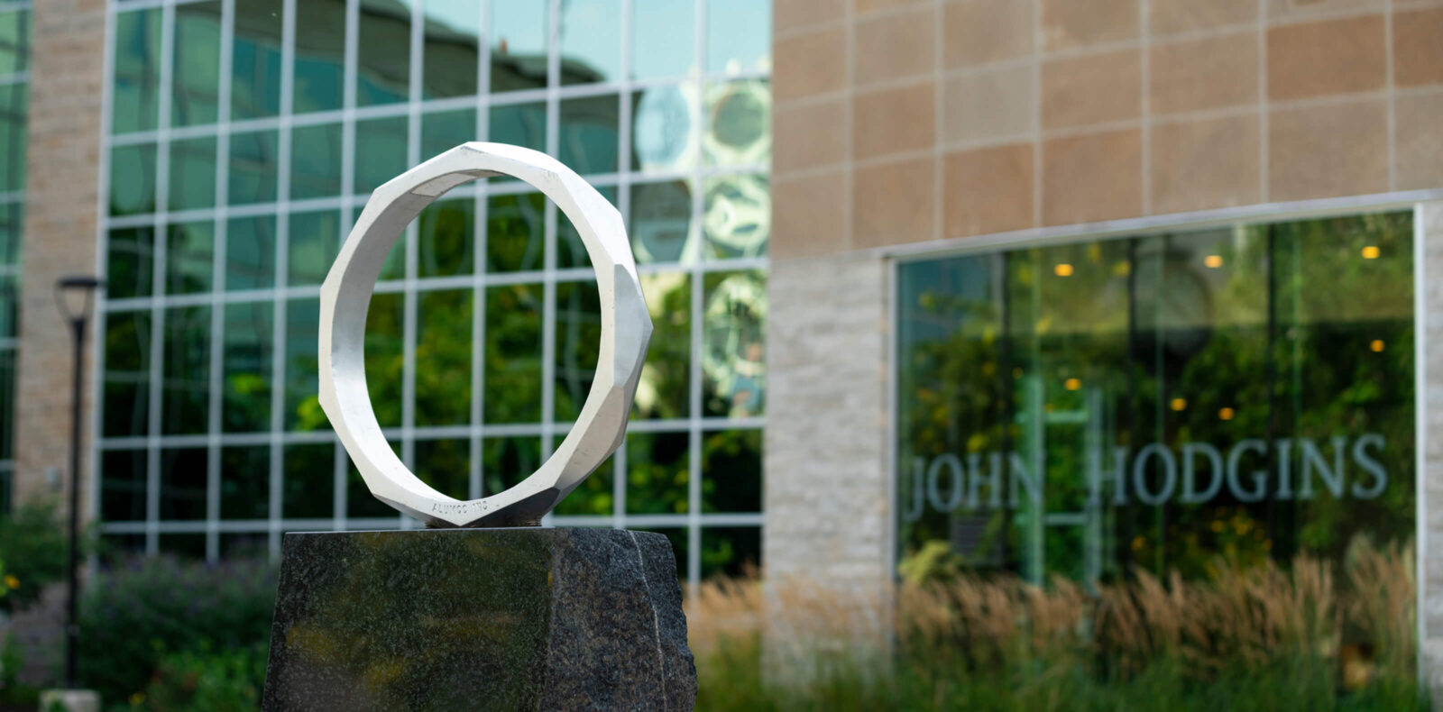 Iron ring in the foreground, with the John Hodgins Engineering Building in the background.