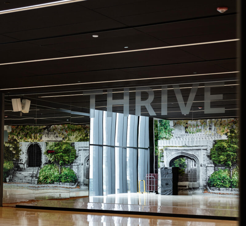 A window that says "Thrive" at the Pulse Fitness Centre.