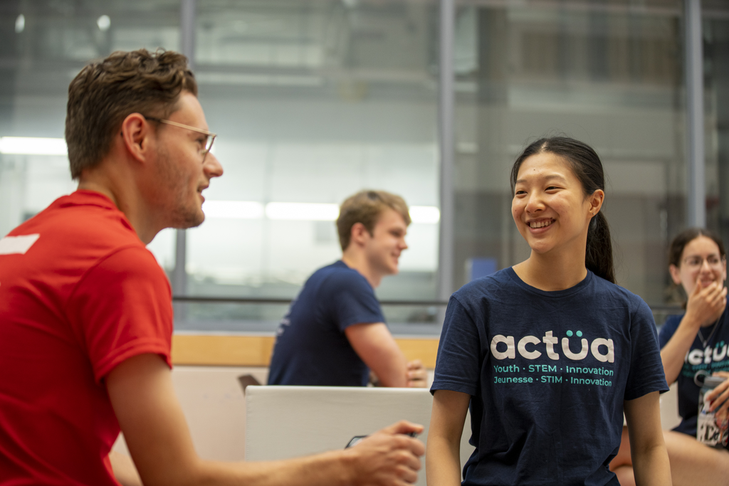 students talking, one wearing an Actua t-shirt