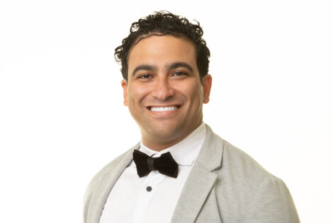 Ryan Ahmed smiling and wearing a bow tie