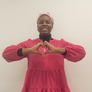 Benita Okosagah poses with heart hands