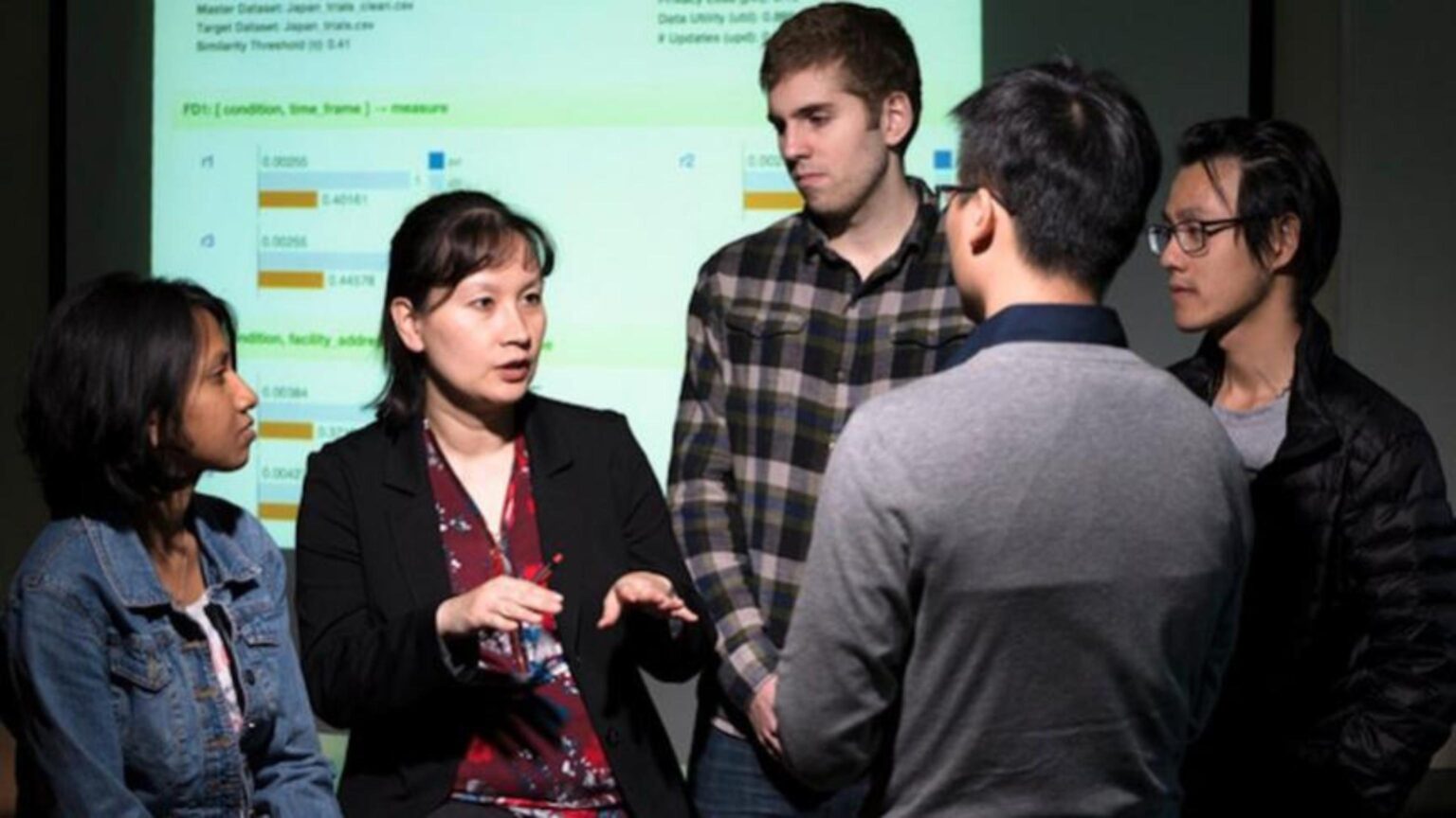 Group of students talking to an instructor