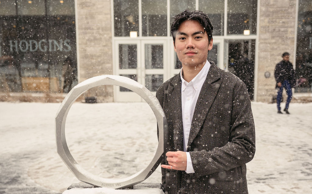 Nick Phan poses with the Iron Ring statue