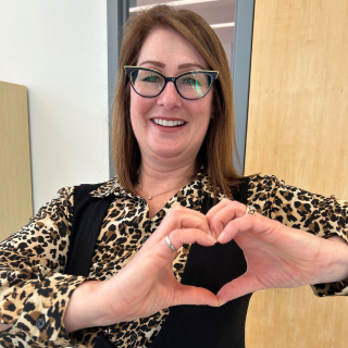 Sarah Dickson-Anderson poses with the heart hand
