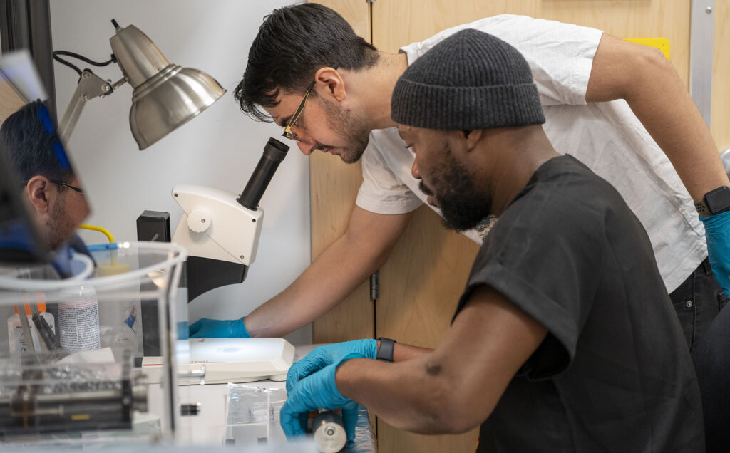 PhD students Babafemi Agboola and Joaquin Eduardo Reyes Gonzalez prepping materials for the electron microscope.