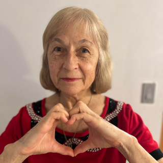 Yotka Rickard poses with heart hands