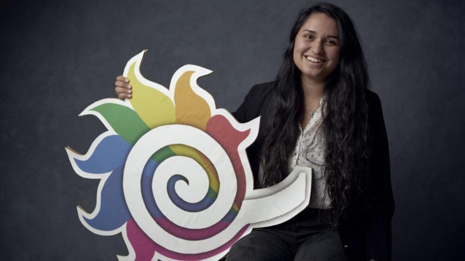 Picture of Vanessa holding a fireball logo