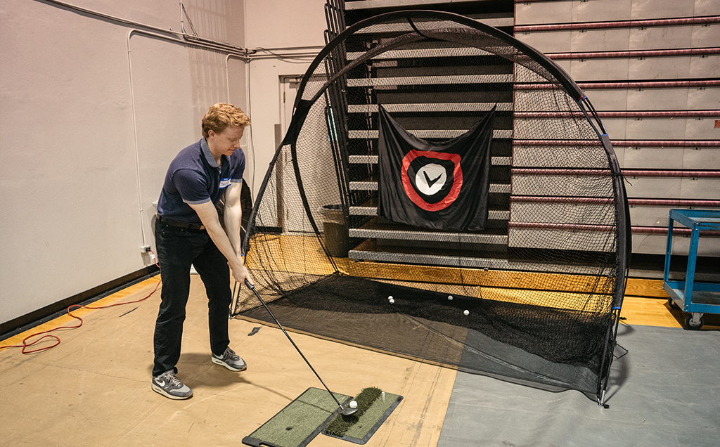 A student preparing to swing the golf club