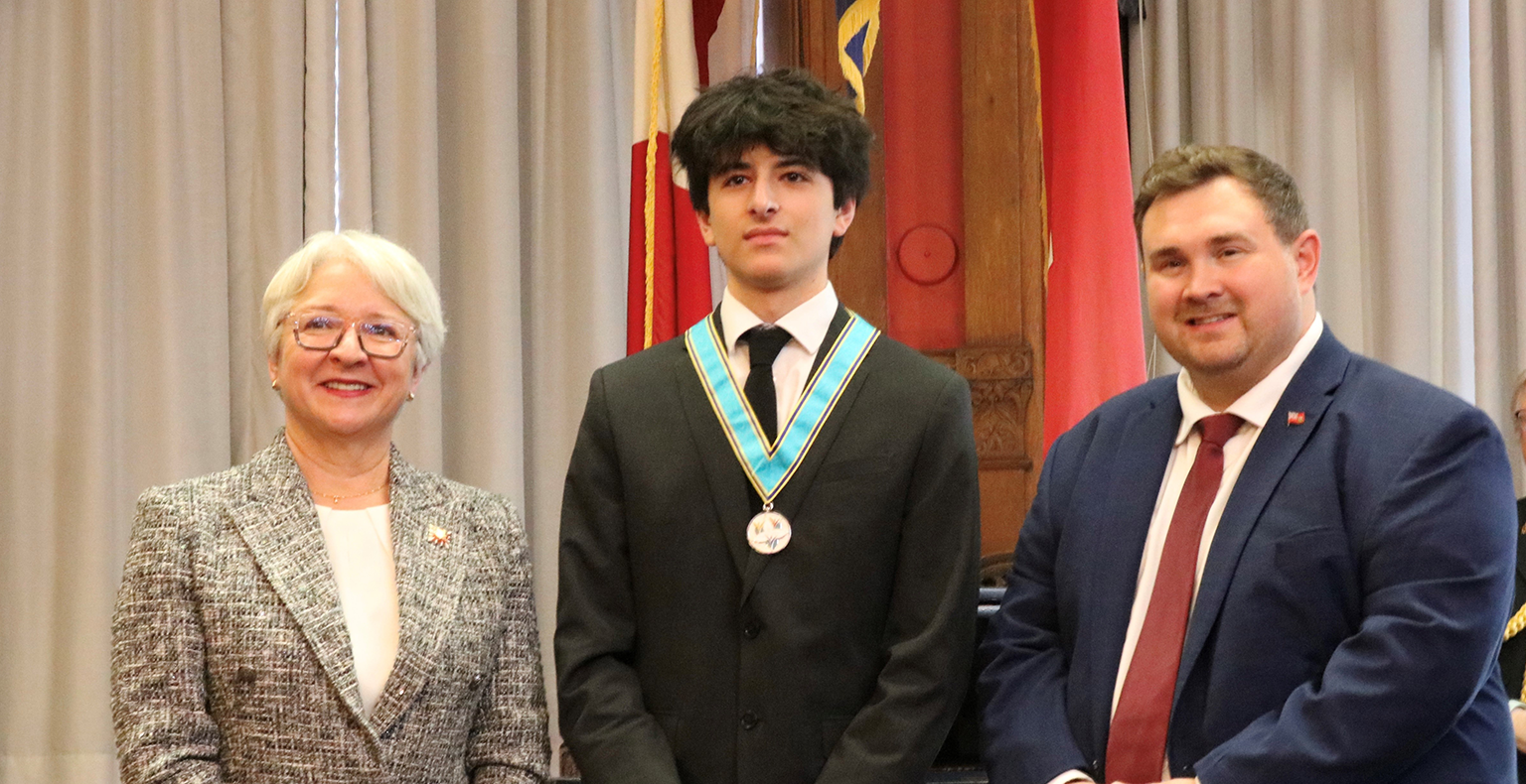 Kusha receiving an award from The Lieutenant Governor and Member of Provincial Parliament