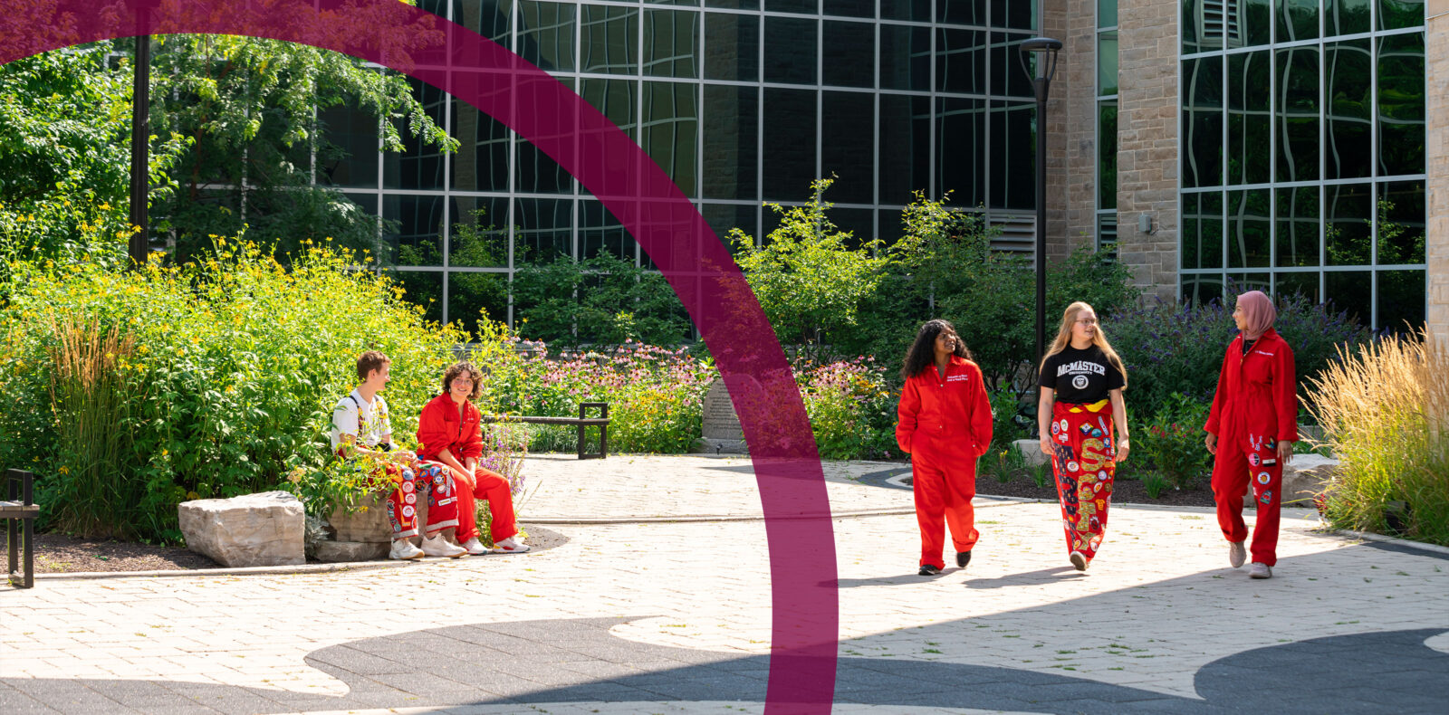 May @ Mac website banner with redsuits walking in front of JHE