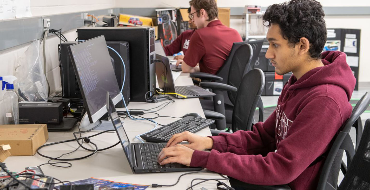 Students working on computers at the McMaster Centre for Software Certification