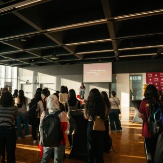 A crowd of students watching a presenter.