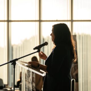 Presenter speaking into a microphone
