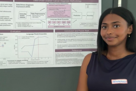 Delina Mekonnen posing with her research poster at a research showcase event.