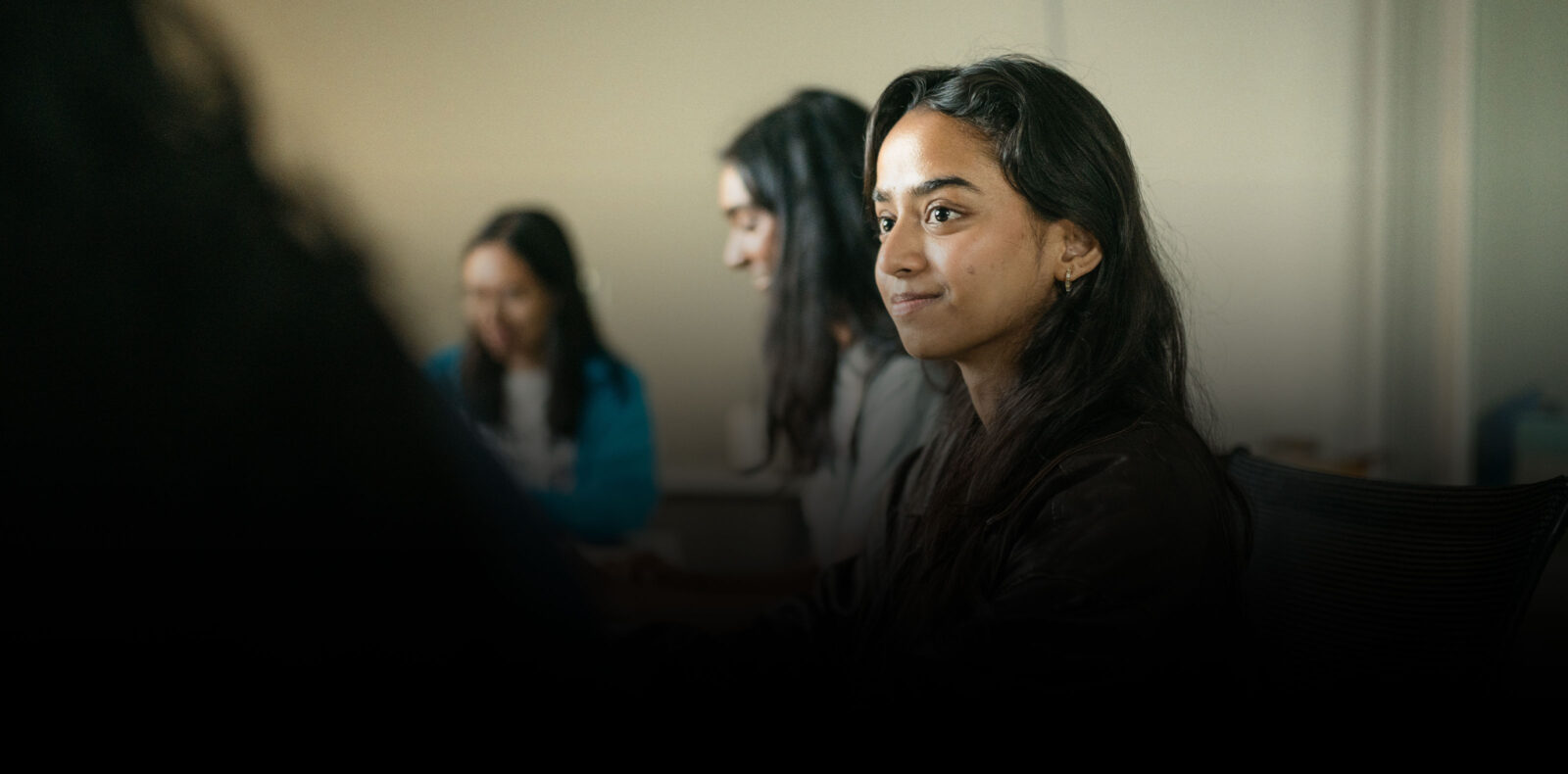 student sitting in class listening