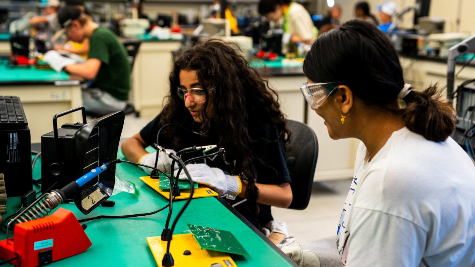 2 student campers working on a project together
