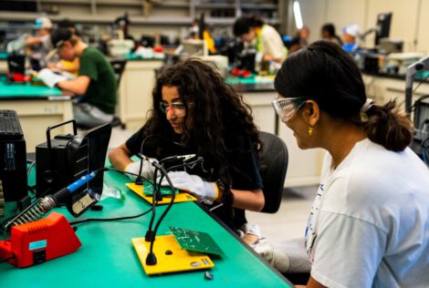 2 student campers working on a project together