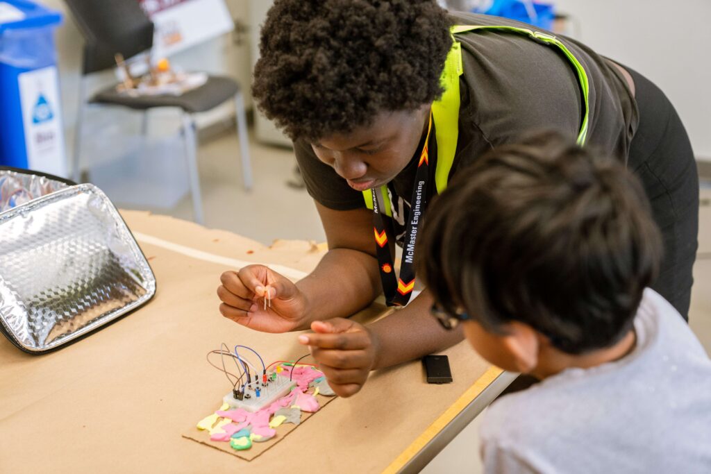2 camp students working on a project together