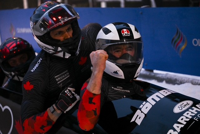 Bobsleigh team seated in a bobsled