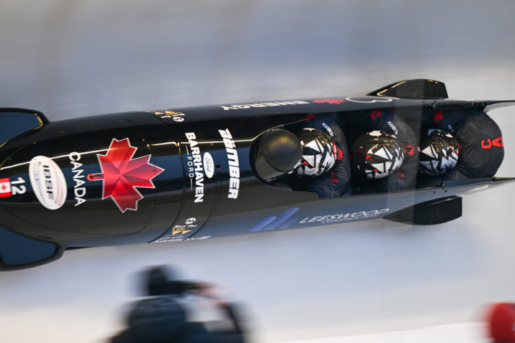 Overhead of Team Canada men's bobsled racing down a track