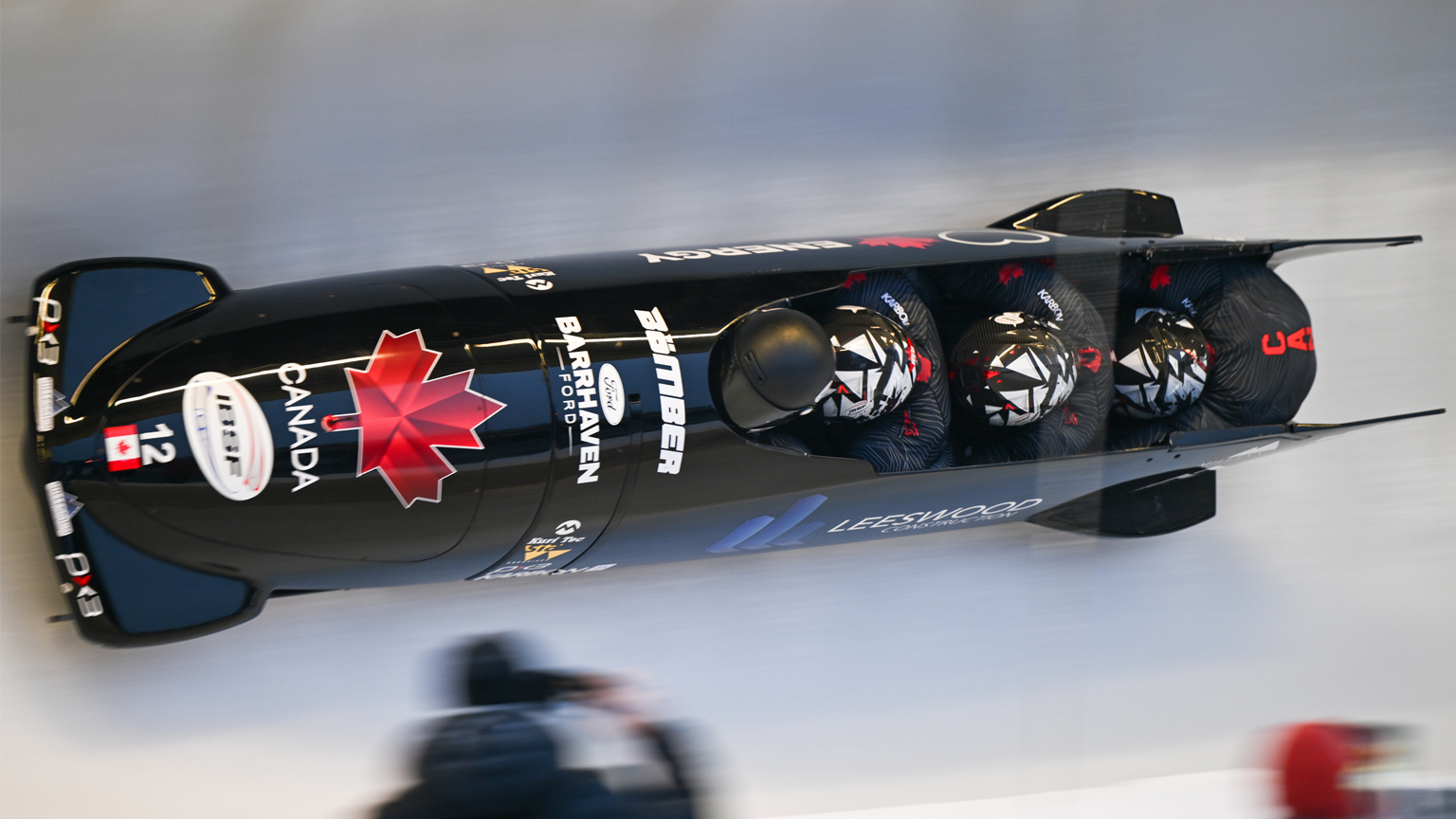 Overhead of Team Canada men's bobsled racing down a track