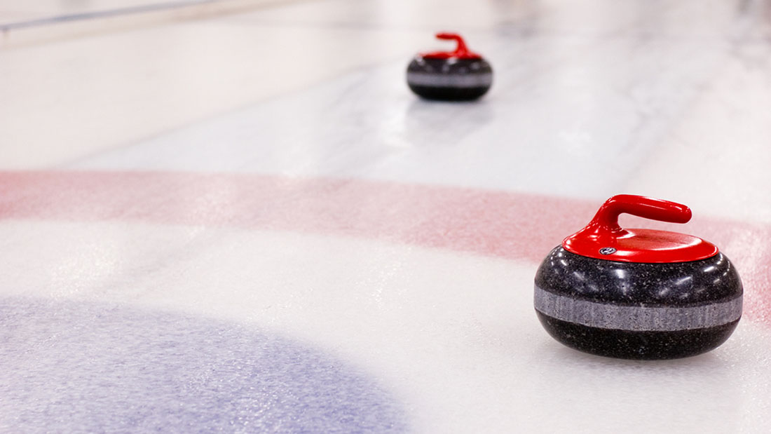 Curling rocks resting on a sheet of ice