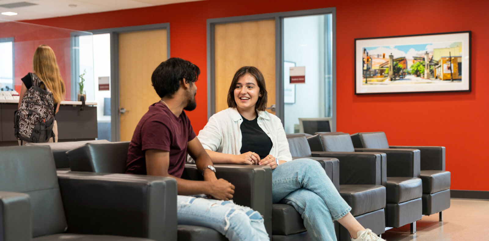 two students talking in the academic and career advising receptioon
