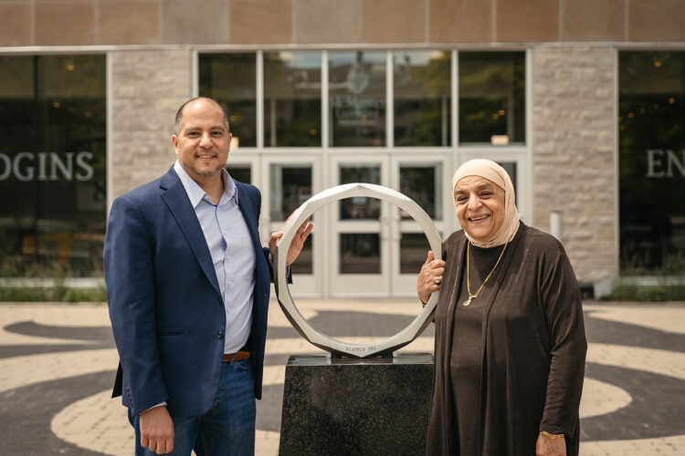 Aly Orady (left) with his mother Soraya (right) posing beside the Iron Ring.