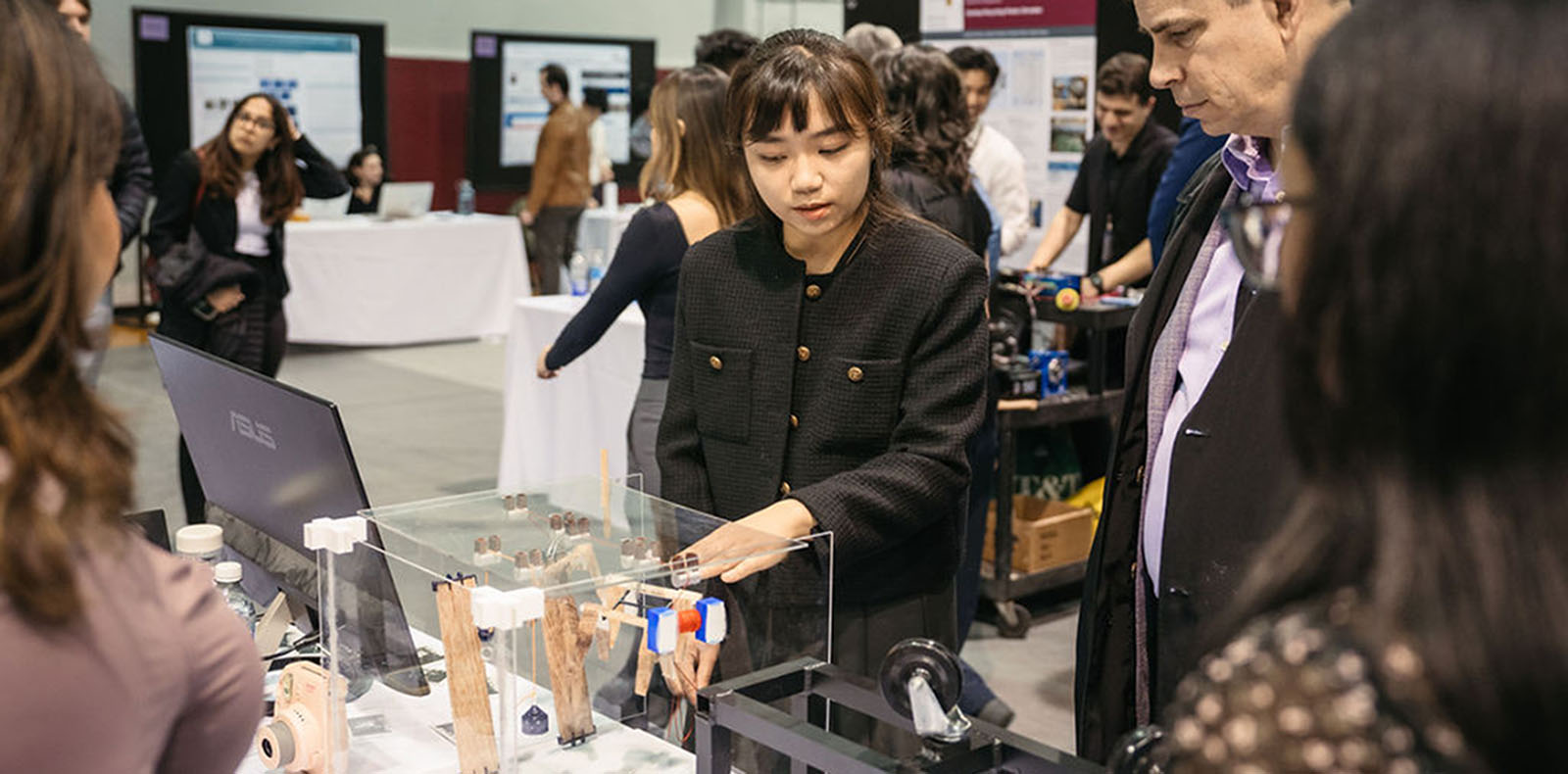 Person showing their capstone project on a table