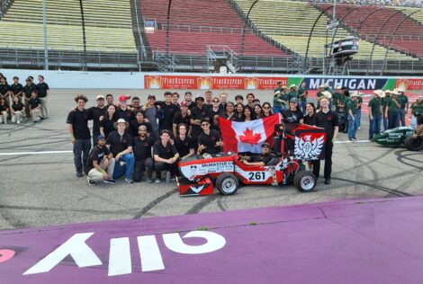 Formula Electric Team in behind the car they designed.