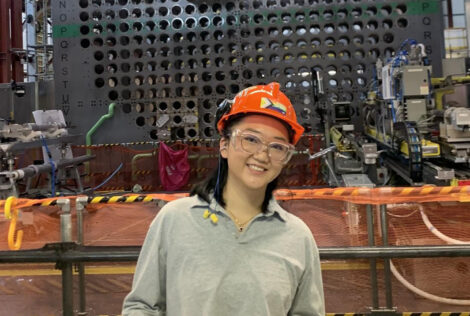 Spring Fu standing in front of a nuclear reactor
