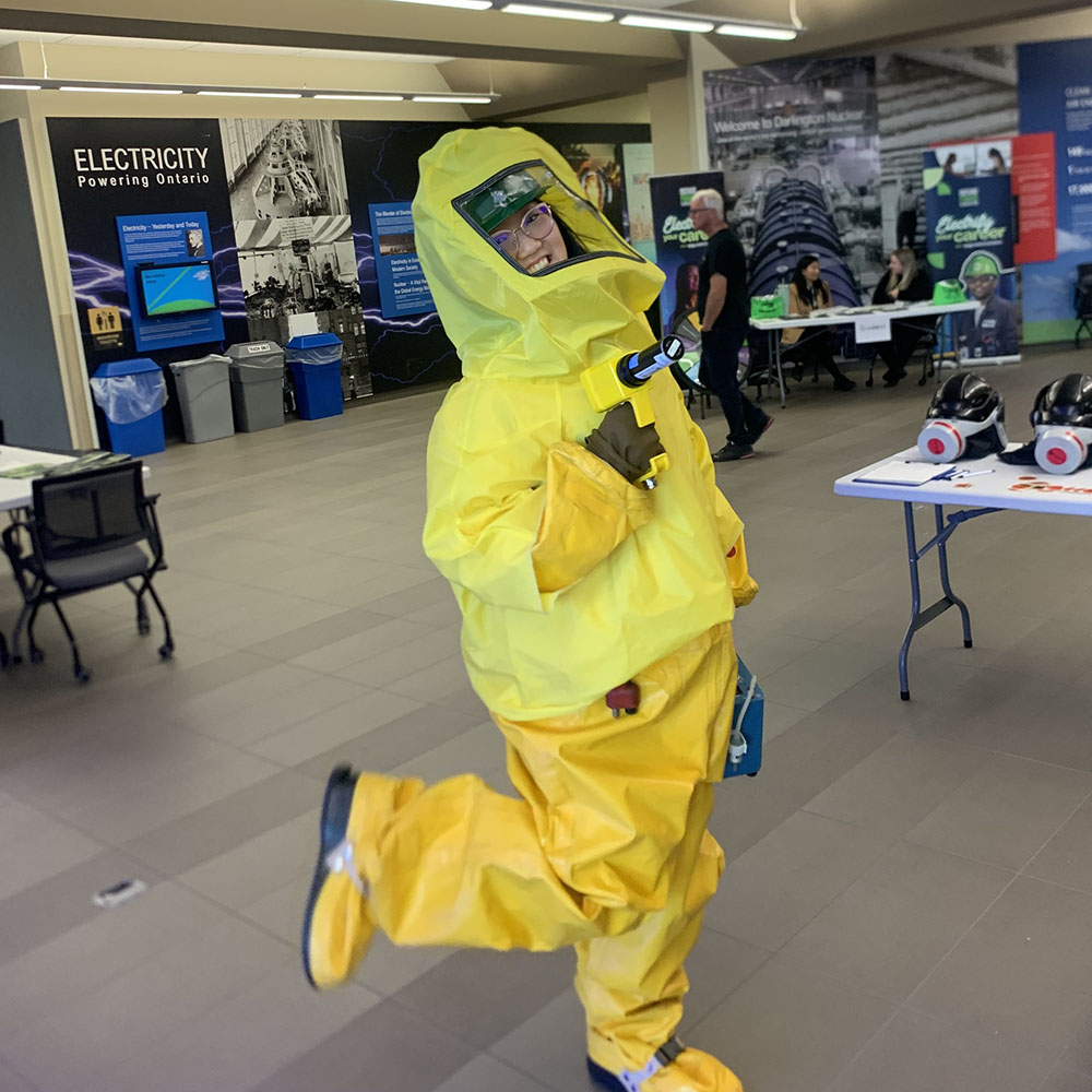 Spring Fu wearing bright yellow PPE holding a tool