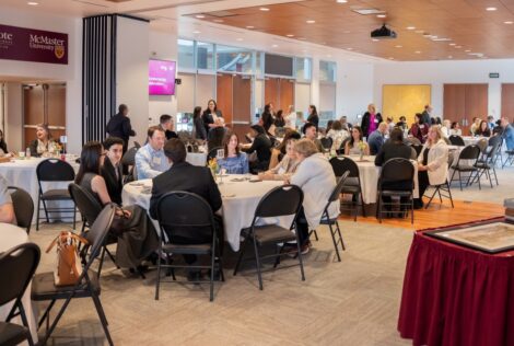 People sitting at round tables at the event
