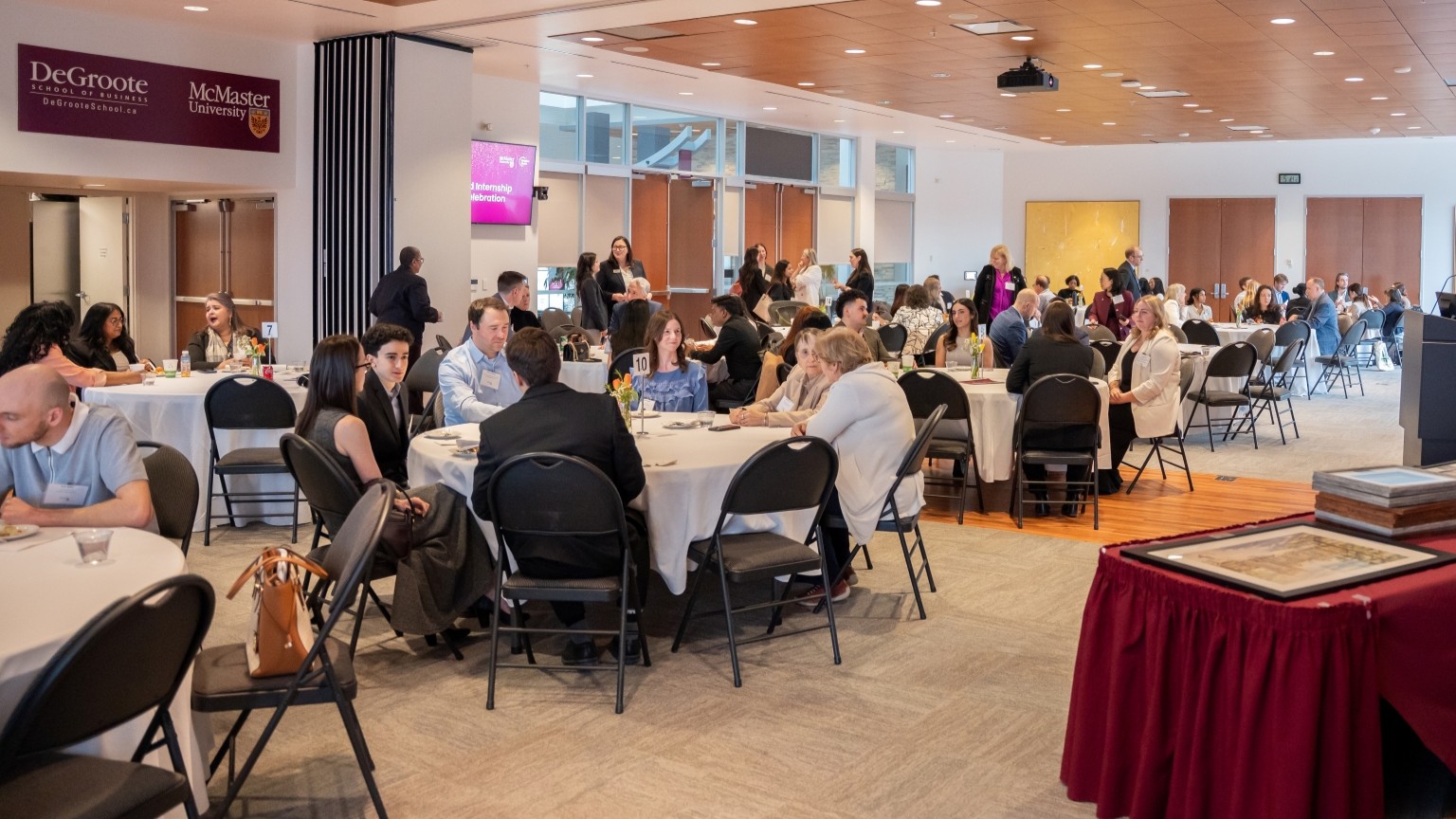People sitting at round tables at the event