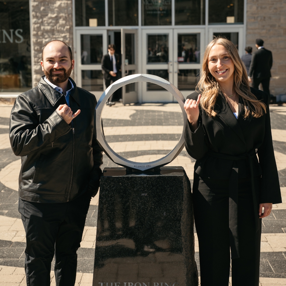 Megan and Samuel pose at the iron ring statue