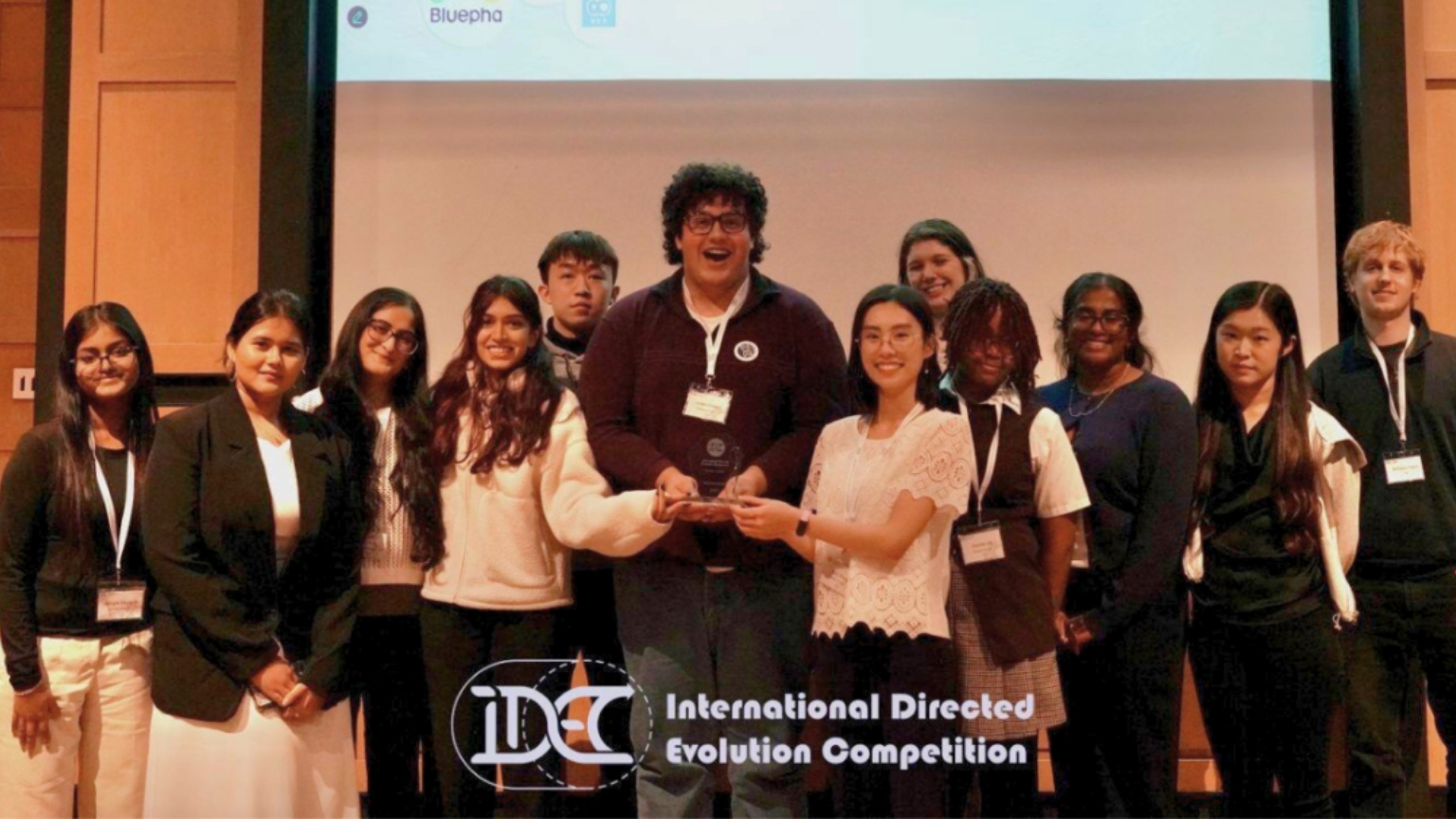 Members of the BioDesign team pose together holding their third place award from an international biomedical competition
