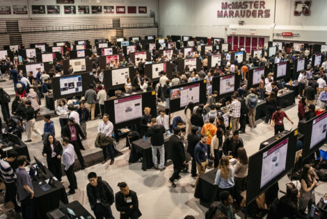 Rows of poster boards and people at the Capstone Expo