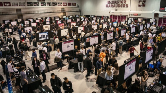 Rows of poster boards and people at the Capstone Expo