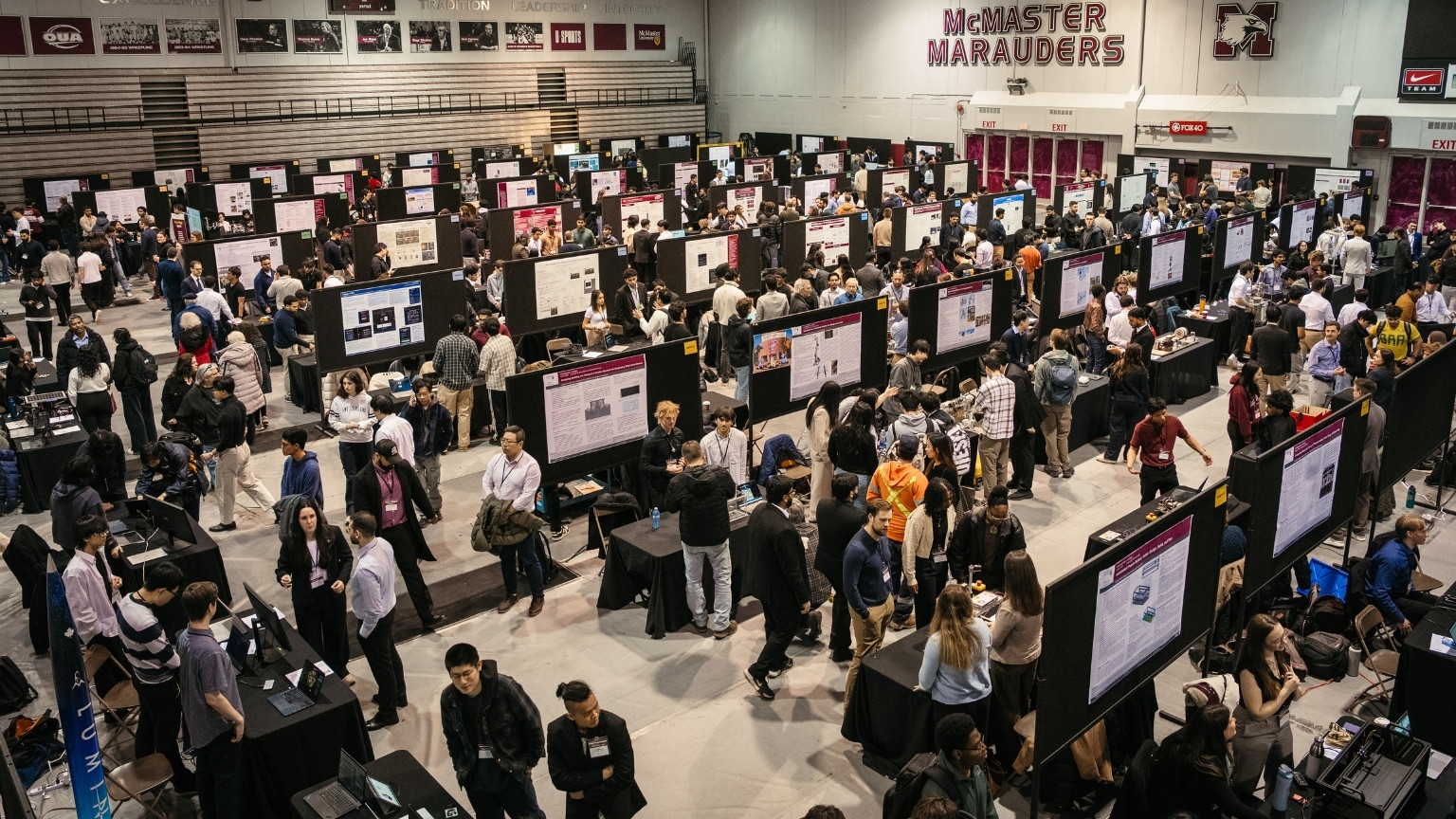 Rows of poster boards and people at the Capstone Expo